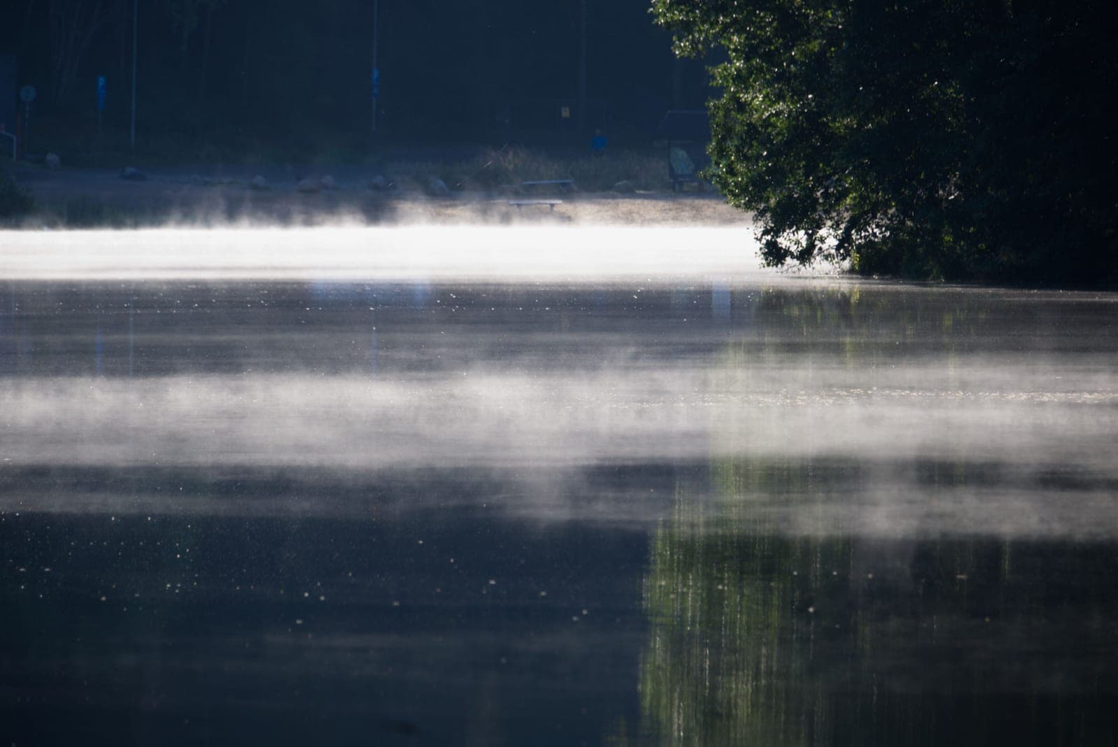 A quiet lake reflecting the sky in early morning light