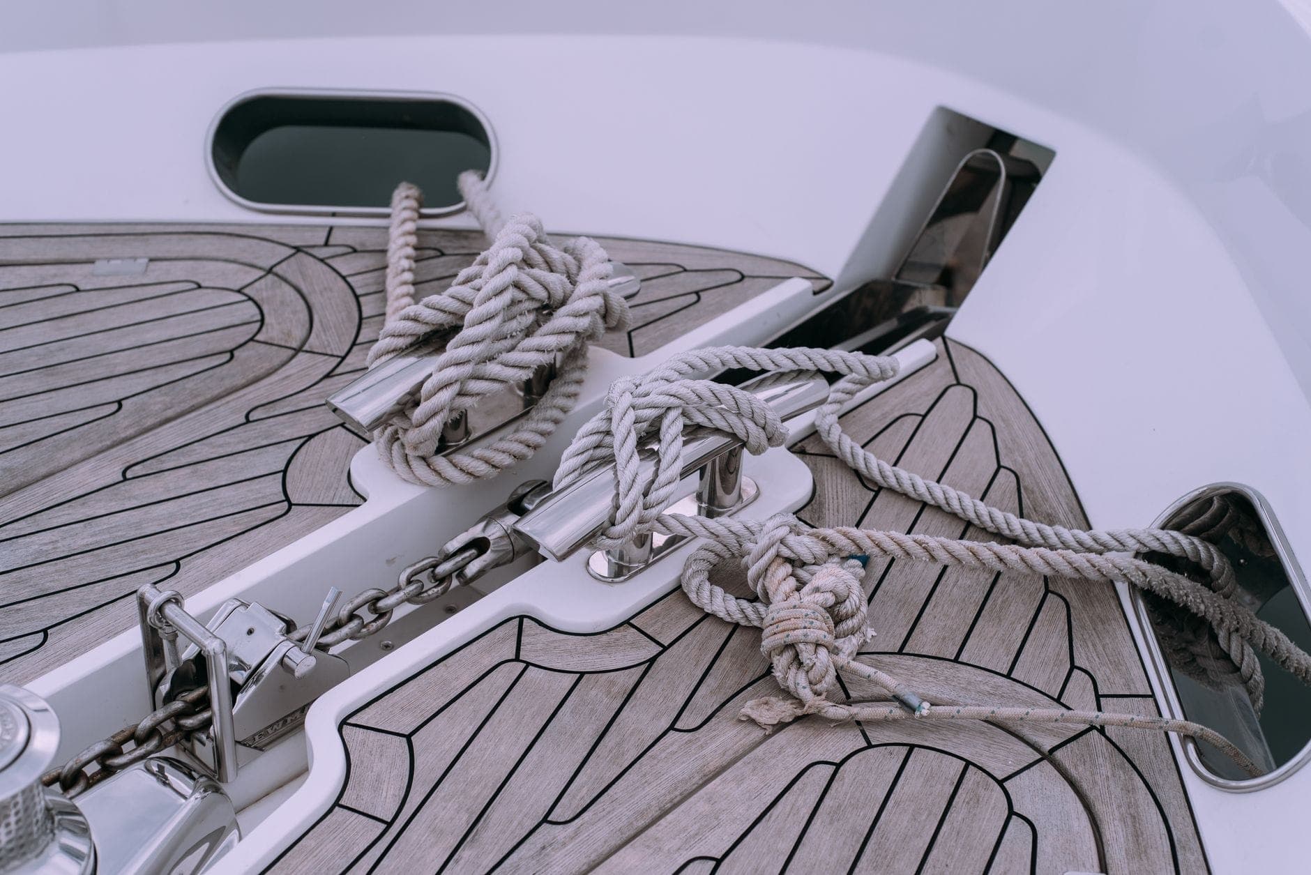 Knotted rope and chain coiled on a boat deck