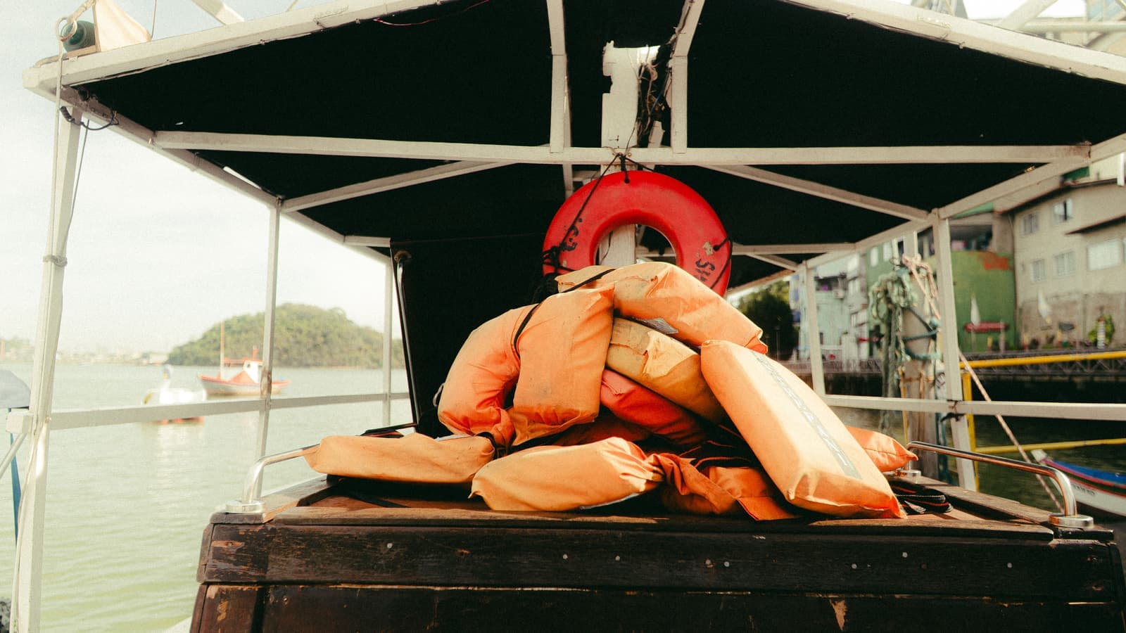 An orange life jacket hanging on a dock