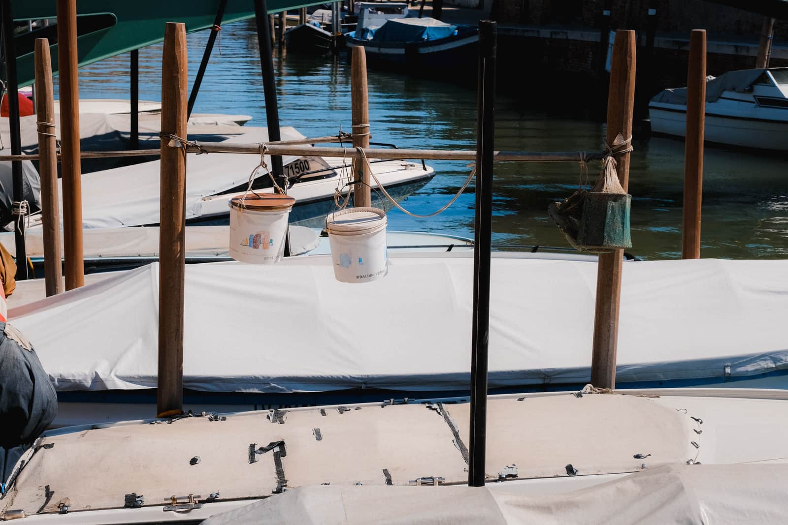 A life jacket hanging on a wooden dock post