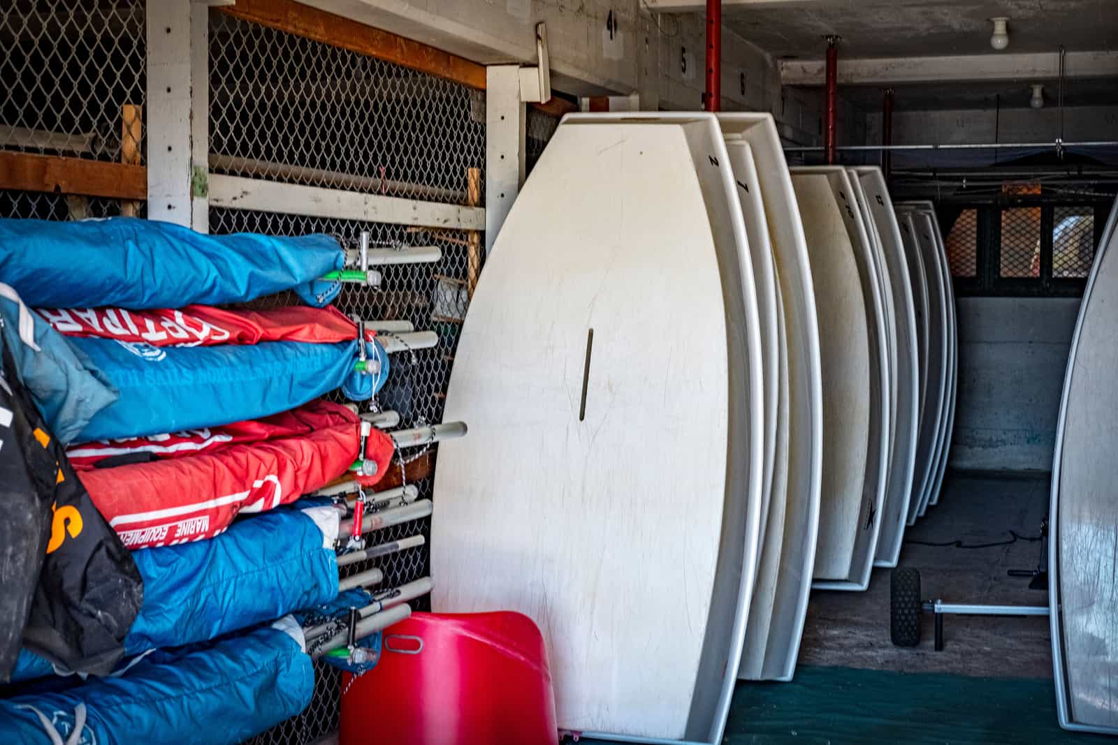 A kayak stored hanging on a garage wall