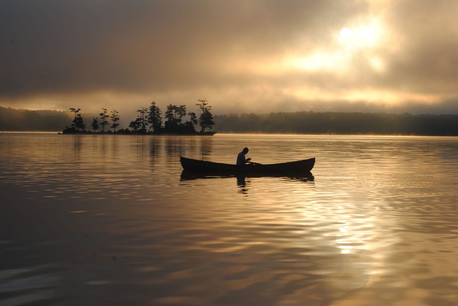 A canoe on still water at sunrise