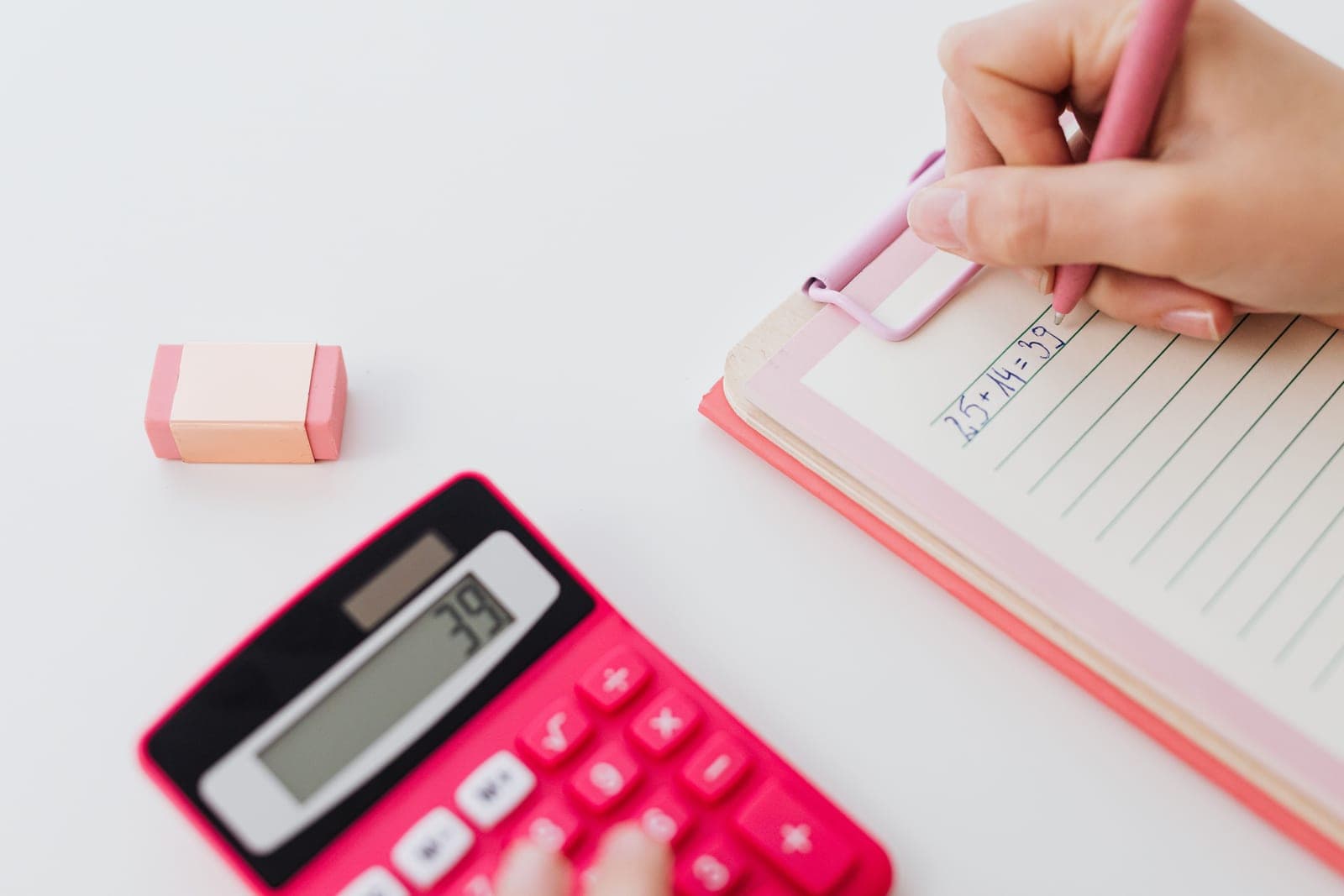A notebook, pen and calculator on a desk