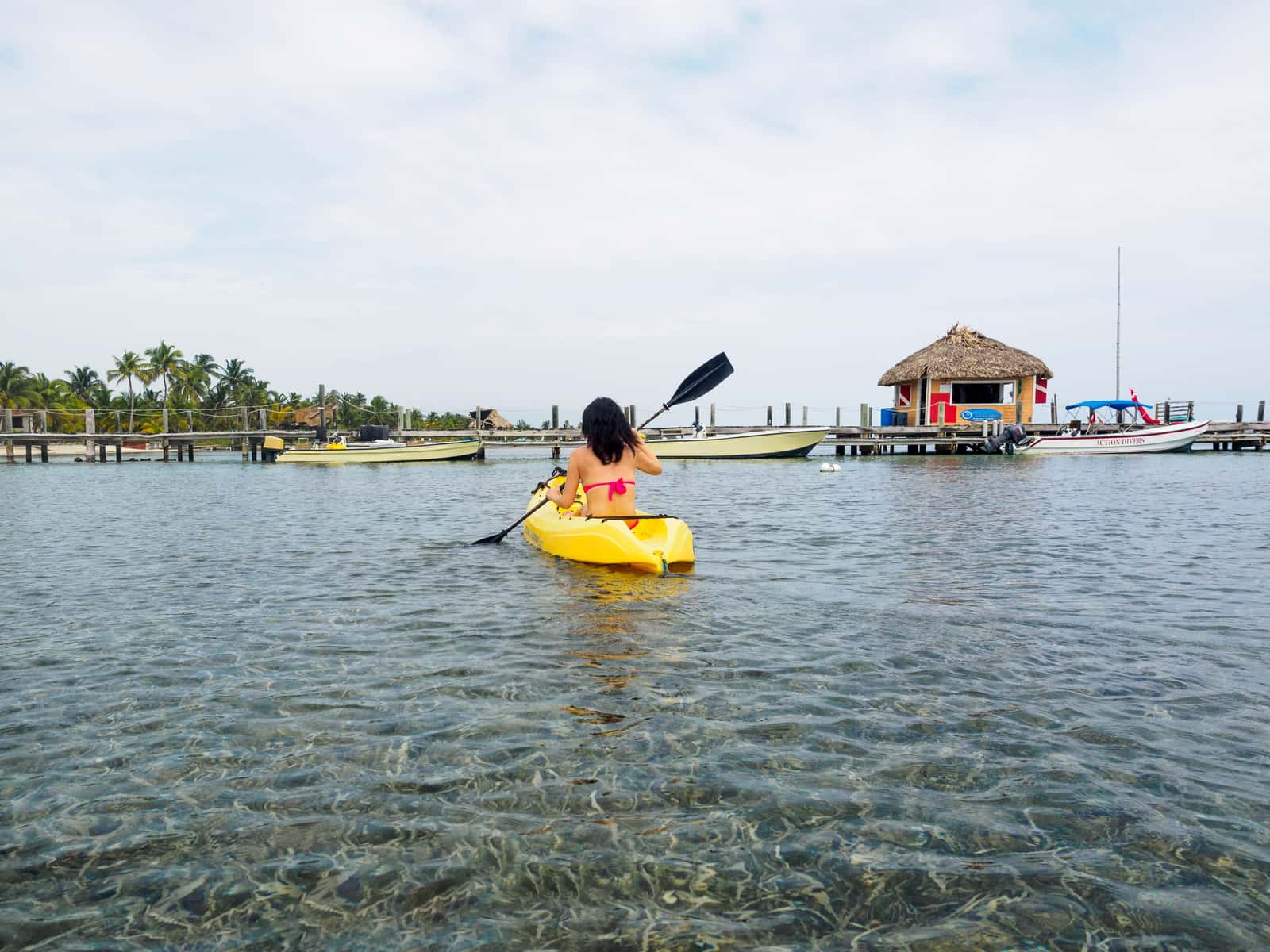 A paddler in a wide stable kayak on open lake water