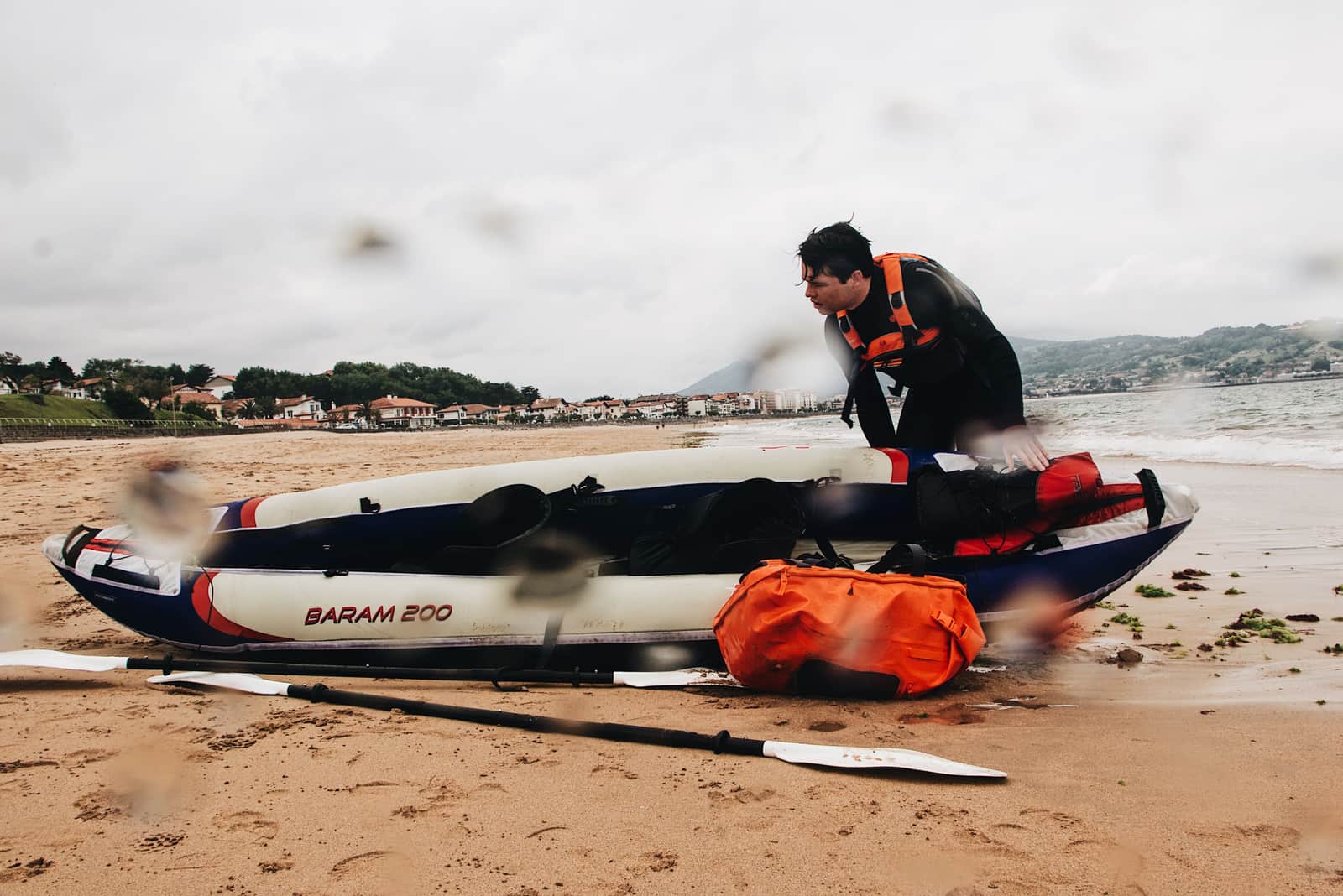 A loaded kayak with dry bags on the shore