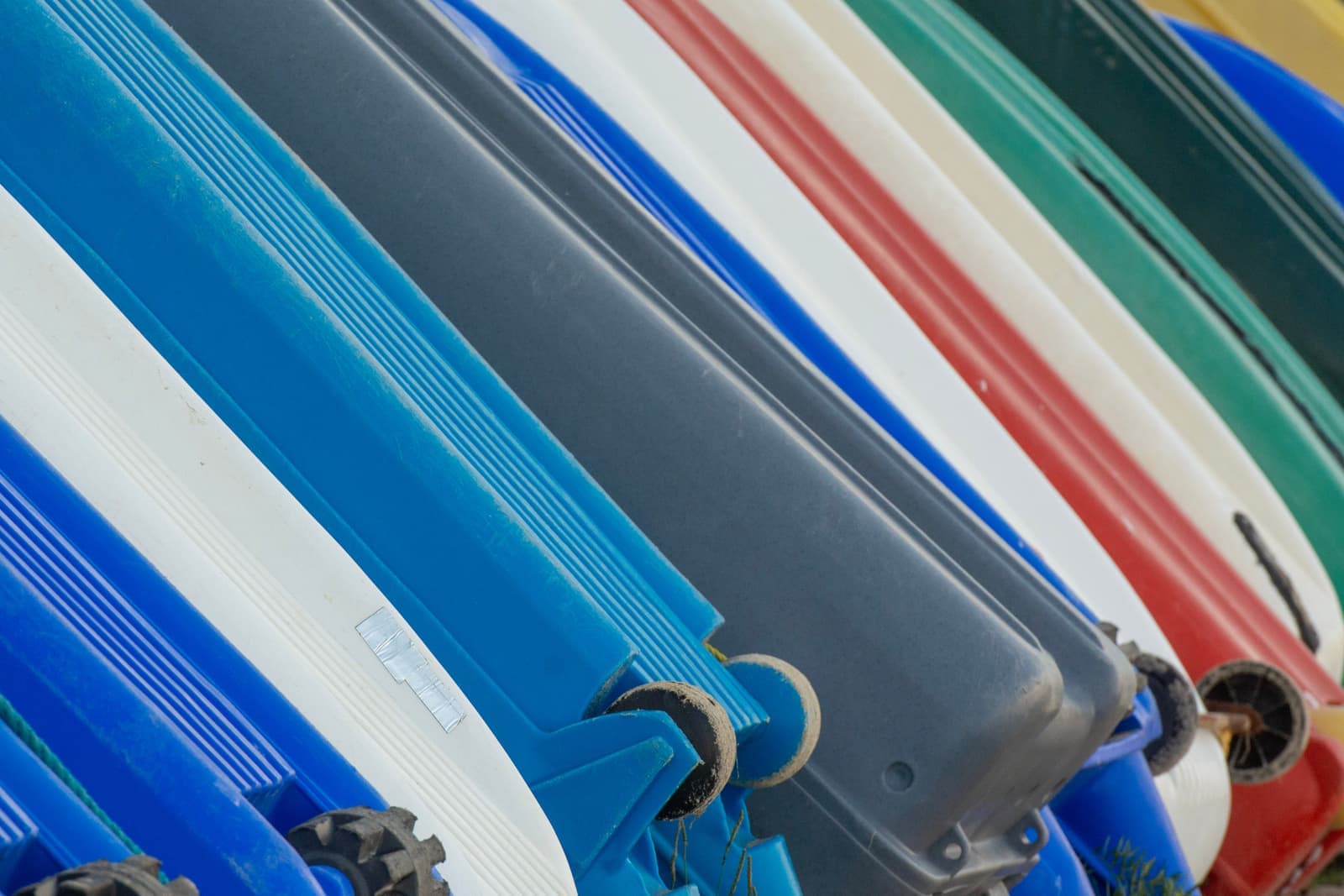 The underside of a kayak hull showing its shape, on the shore