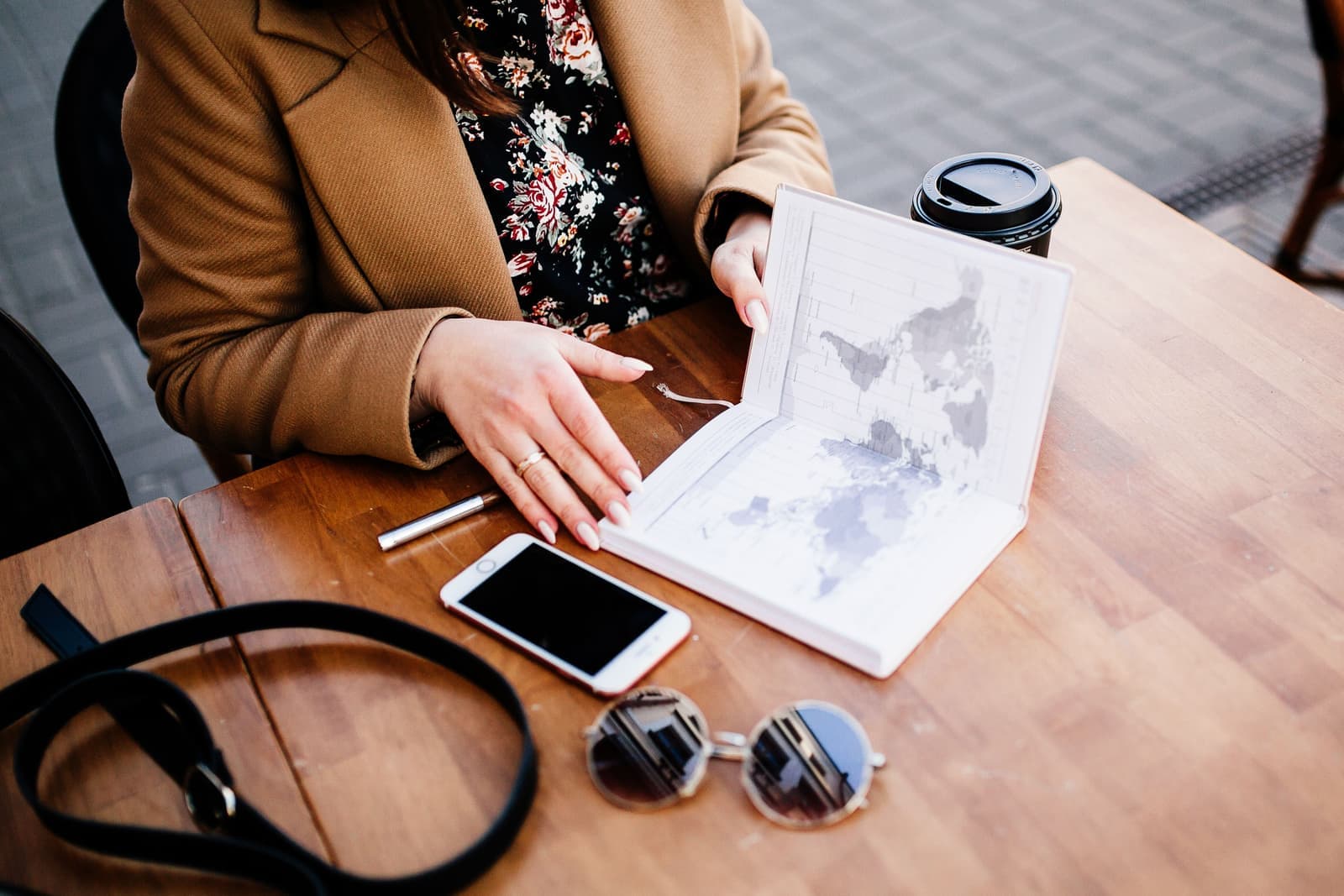 A notebook and map beside a lake dock in the morning
